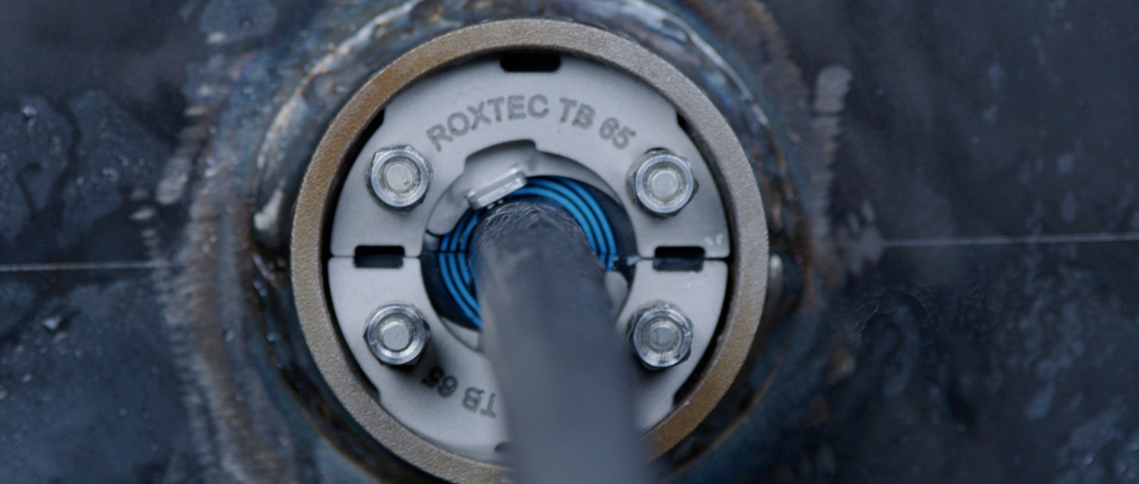 Cable and pipe seals for tank boundaries